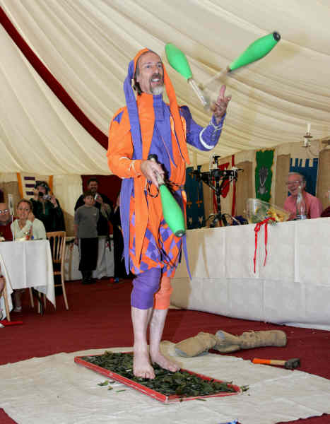Juggling Jester walking on broken glass